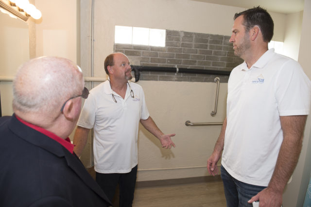 Dale and Rob show off the new wheelchair accessible bathroom