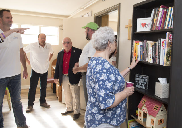 Guests check out the bookcase in our newly remodeled living/dining room